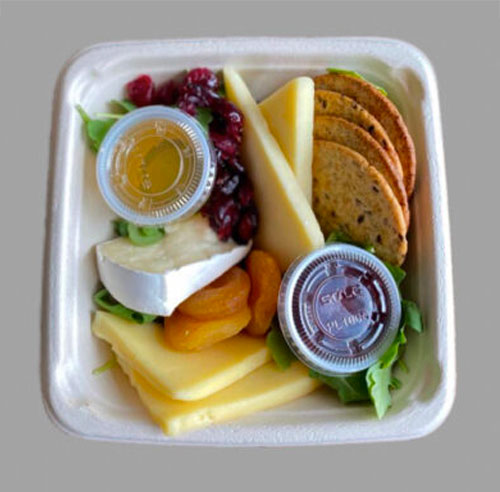 An individual tray with a fresh selection of soft and hard cheeses, crackers, dried cranberries, nuts and 2 special sauces. This tray serves 1 to 2 people.